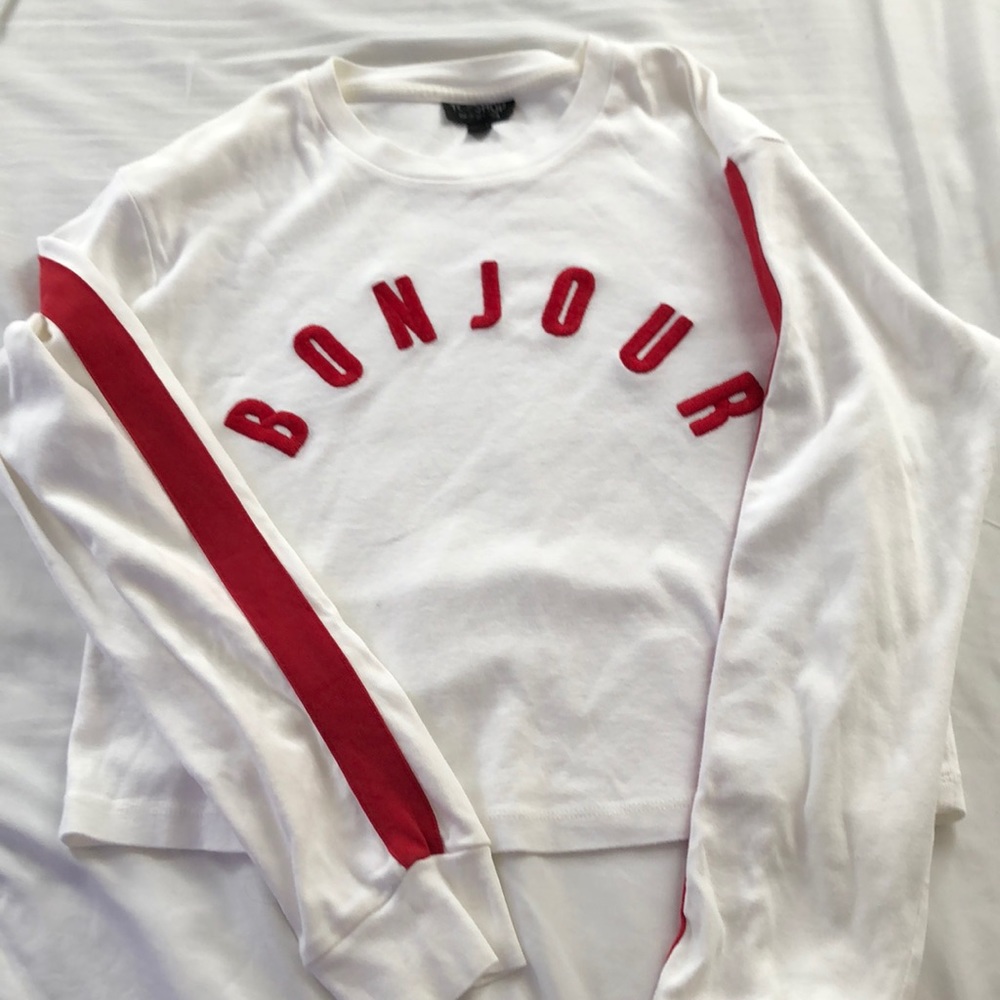 White sweater with red detail